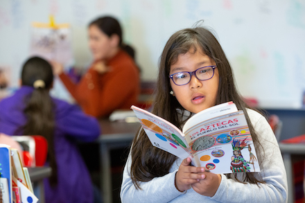 Student reads a book in spanish