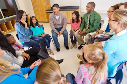 Students and families at a meeting