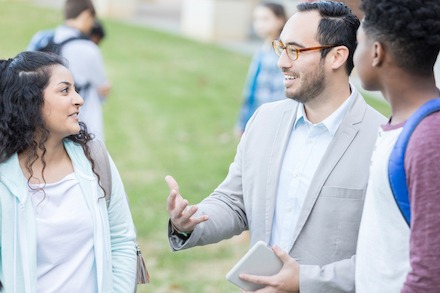 Students and parents talk outside